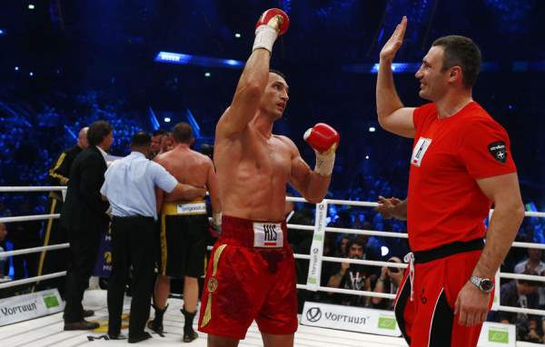 Heavyweight boxing world champion Klitschko celebrates with his brother Vitali after defeating Pianeta in Mannheim