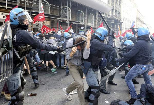 Demonstrators fight with policemen during a protest in downtown Rome