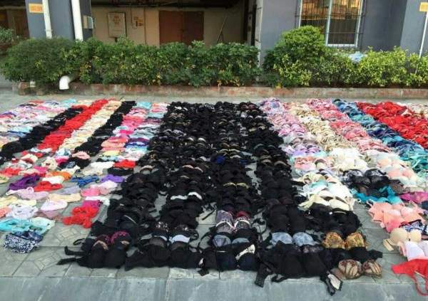 Hundreds of stolen women's underwear are placed on the ground after being found hidden in the ceiling of a apartment building, in Yulin
