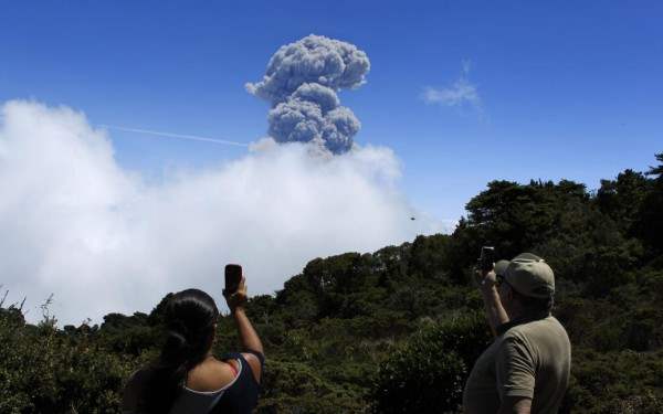 People take pictures of an eruption of the Turrialba volcano, from San Gerardo de Irazu near Turrialba